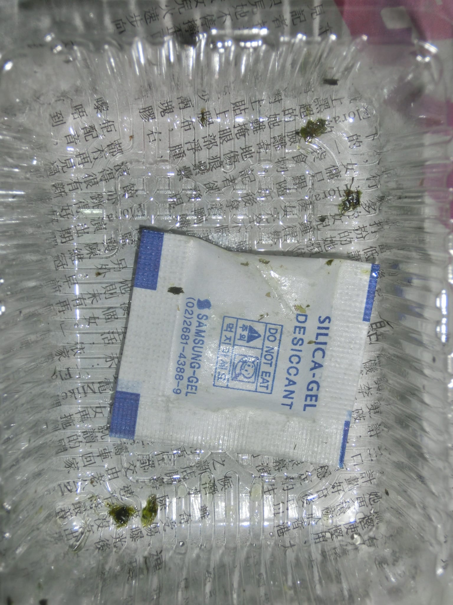 A silica gel desiccant packet in consumer packaging, the kind found in electronics boxes.