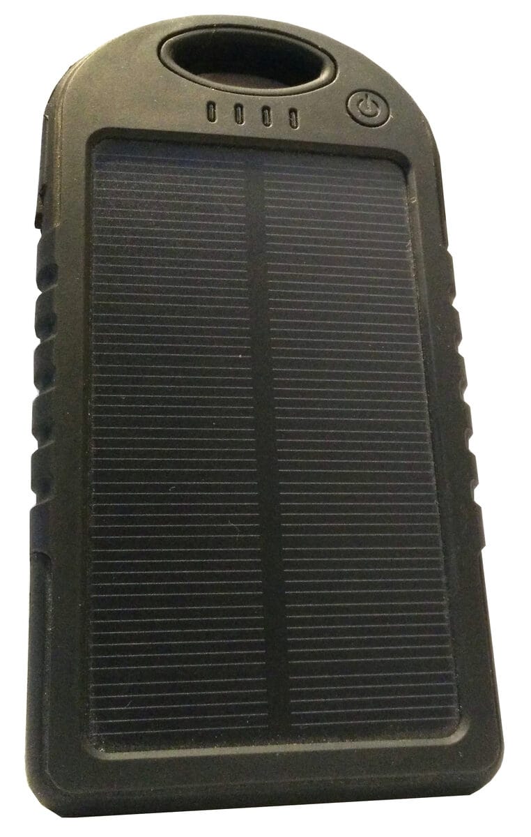A compact portable power bank with a small integrated solar panel for off-grid USB charging, photographed on a wooden surface.