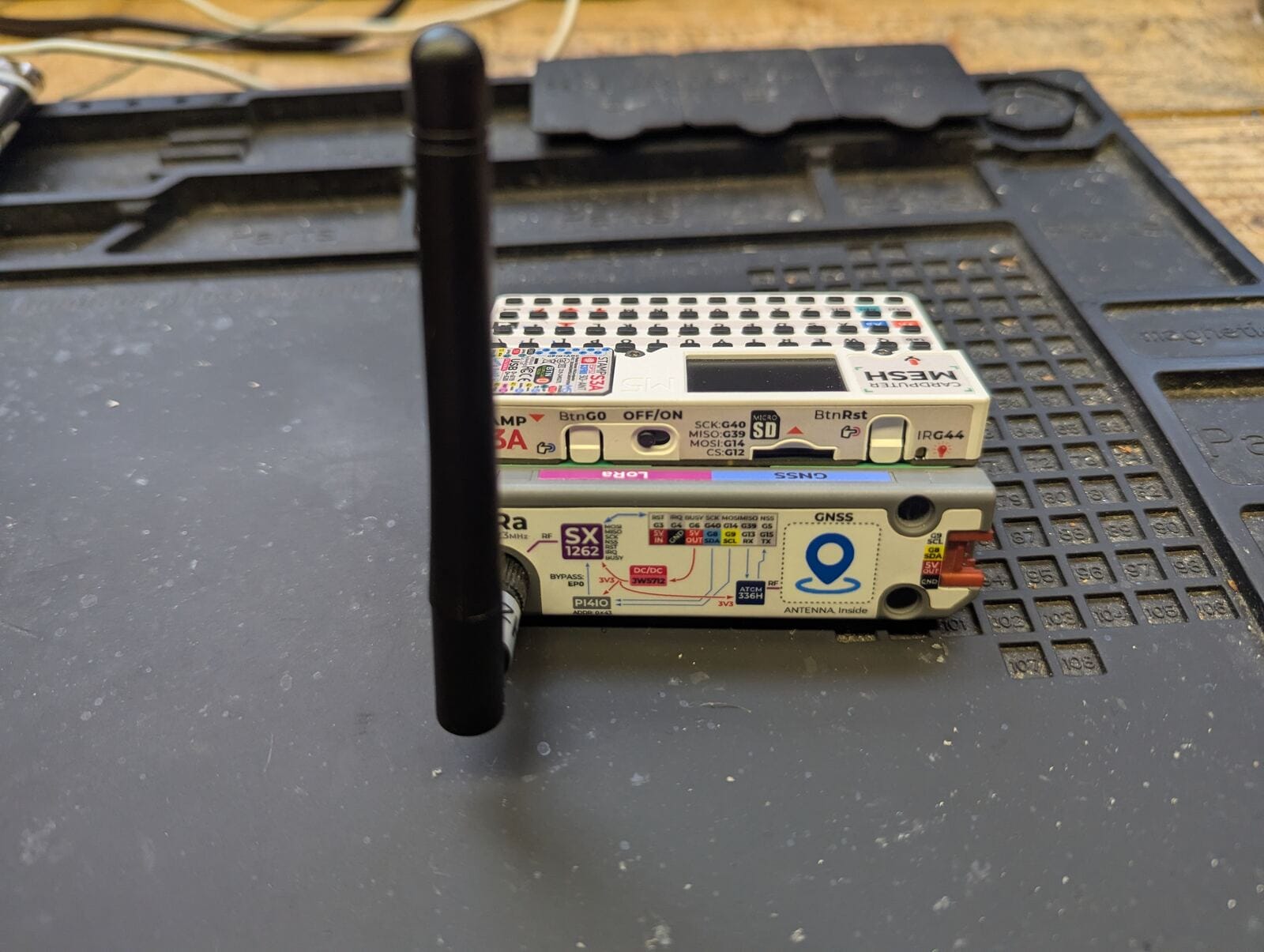 Side view of the M5Stack Cardputer showing the SX1262 LoRa and GNSS module stacked on top of the keyboard unit with its antenna attached